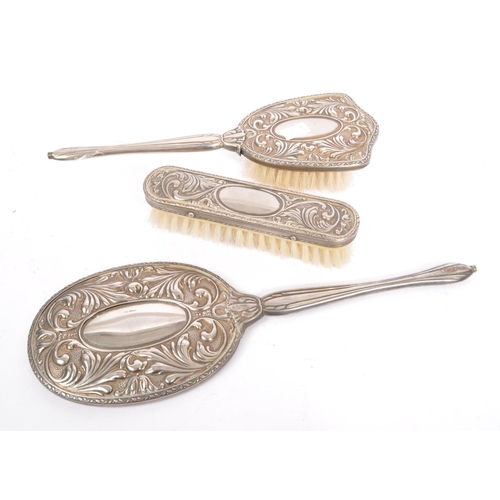 375 - A vintage 20th century Art Nouveau style silver plated vanity set. Comprising of clothes brush, hair... 