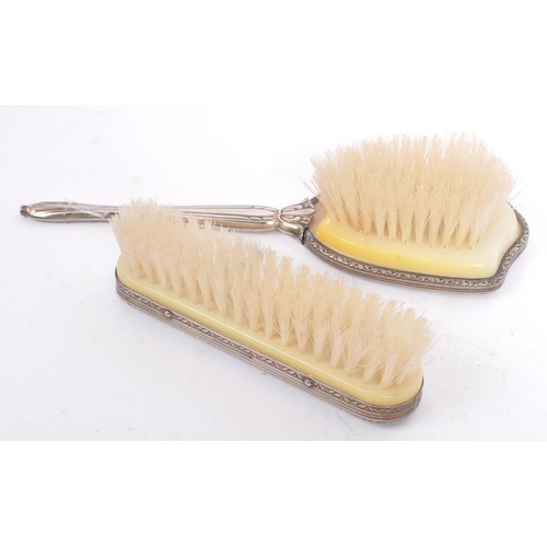 375 - A vintage 20th century Art Nouveau style silver plated vanity set. Comprising of clothes brush, hair... 