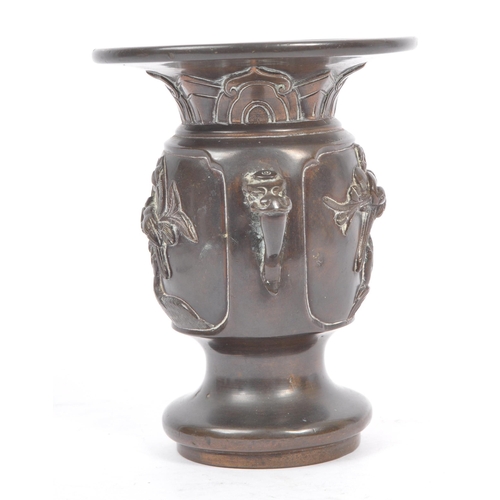 393 - A late 19th century Qing dynasty chinese bronze urn vase. The vase with Illustrated raised relief bi... 