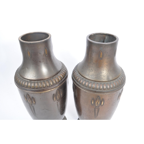 395 - A pair of 1920s matching brass vases in the Art Nouveau style. With raised curved and elongated patt... 