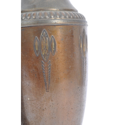 395 - A pair of 1920s matching brass vases in the Art Nouveau style. With raised curved and elongated patt... 