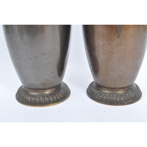 395 - A pair of 1920s matching brass vases in the Art Nouveau style. With raised curved and elongated patt... 