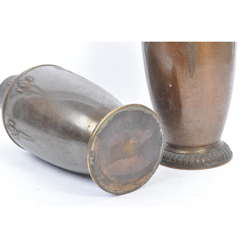 395 - A pair of 1920s matching brass vases in the Art Nouveau style. With raised curved and elongated patt... 