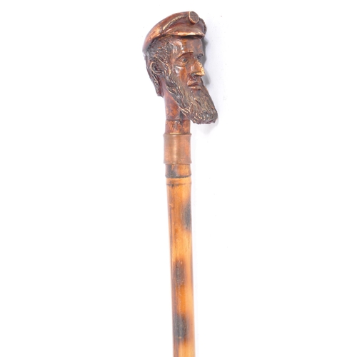 398 - Two early 20th century walking sticks / swagger canes. One example of metal construction with Africa... 