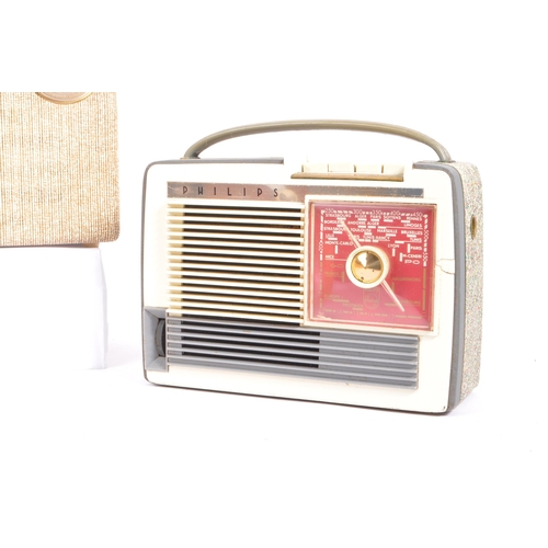 424 - A collection of four mid 20th century portable transistor radios. The collection to include examples... 