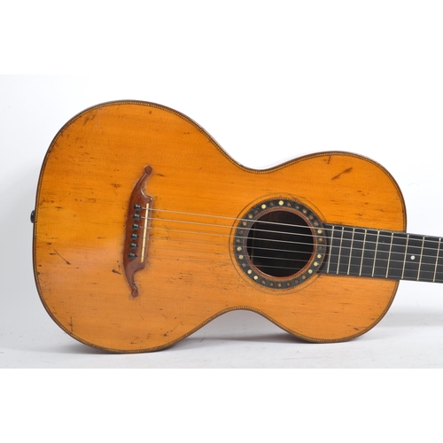 439 - A small proportioned 19th century handmade guitar. The guitar having a walnut body with bow back and... 