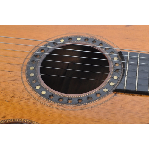 439 - A small proportioned 19th century handmade guitar. The guitar having a walnut body with bow back and... 