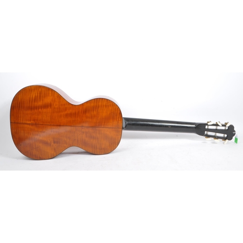 439 - A small proportioned 19th century handmade guitar. The guitar having a walnut body with bow back and... 