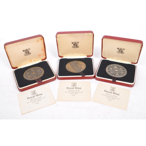 446 - A 20th century 1975 Royal Mint commemorative Tower Hill hallmarked medal coin, alongside two others ... 