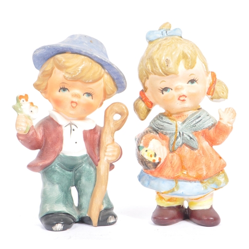 46 - W. Goebel - A collection of early 20th century German W. Goebel and other Hummel manner figurines. T... 