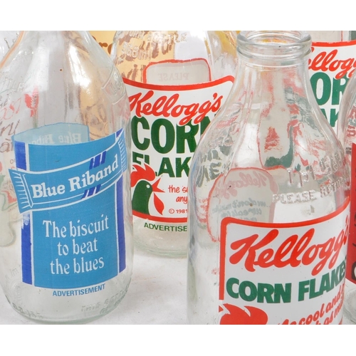 54 - A collection of 32 vintage 1980s glass 1pt / 568ml British milk bottles. Each with individual advert... 