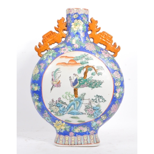 6 - An early 20th century Chinese twin handled porcelain moon flask vase. The vase having white central ... 