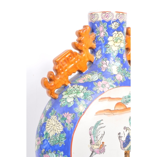 6 - An early 20th century Chinese twin handled porcelain moon flask vase. The vase having white central ... 