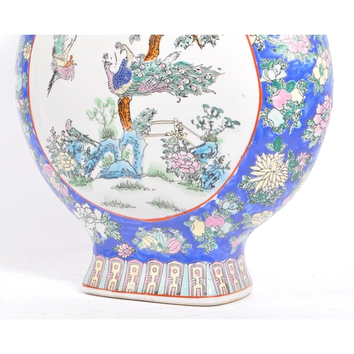 6 - An early 20th century Chinese twin handled porcelain moon flask vase. The vase having white central ... 