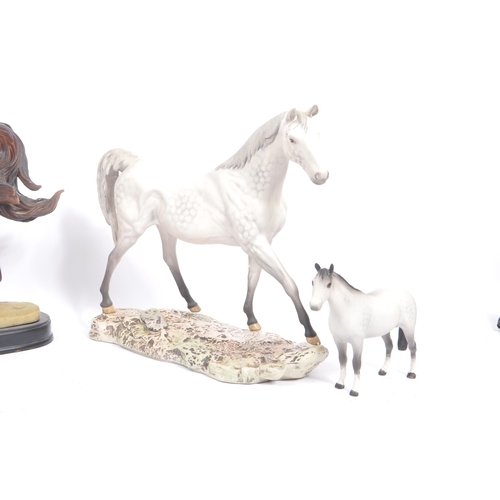 66 - Beswick - A collection of porcelain figurines in the form of horses. Three Beswick examples one with... 