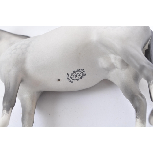 66 - Beswick - A collection of porcelain figurines in the form of horses. Three Beswick examples one with... 