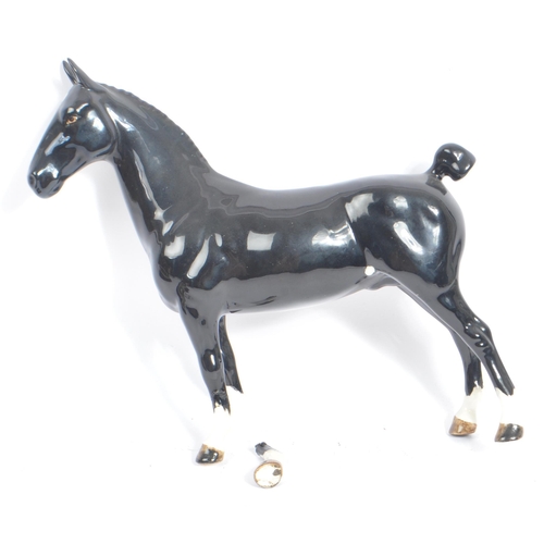 72 - Beswick - A collection of four porcelain china horse figurines. Comprising of a Black Hackney Horse ... 