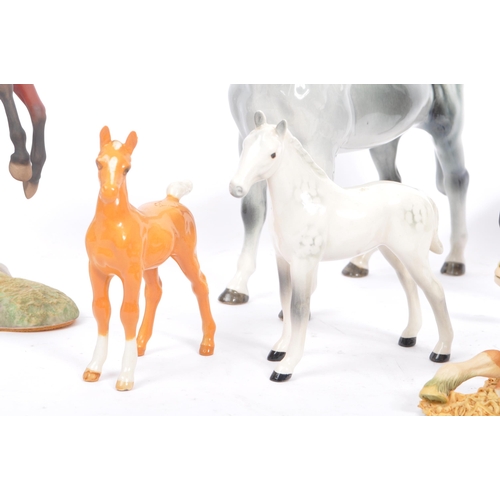 74 - Beswick - A collection of four porcelain display horse figurines. A black foal example, with palomin... 