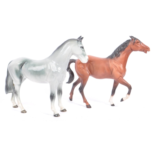 74 - Beswick - A collection of four porcelain display horse figurines. A black foal example, with palomin... 