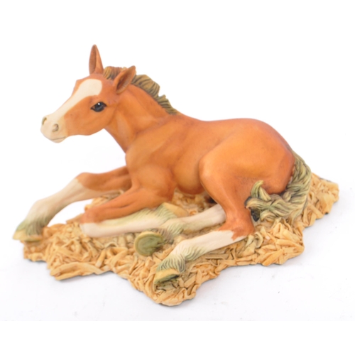 74 - Beswick - A collection of four porcelain display horse figurines. A black foal example, with palomin... 