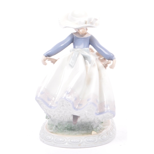 96 - Lladro - Barrow of Fun - A porcelain china tableware figurine / statue. Depicting a young female hol... 