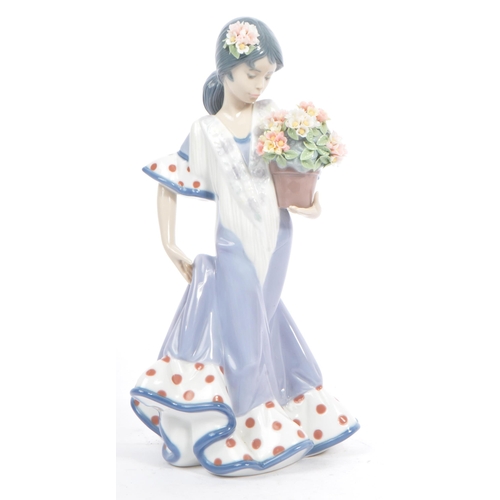 98 - Lladro - Flora Maria - A late 20th century circa 1980s porcelain china figurine. A Hispanic female h... 