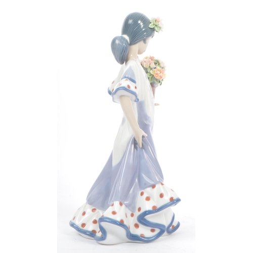 98 - Lladro - Flora Maria - A late 20th century circa 1980s porcelain china figurine. A Hispanic female h... 