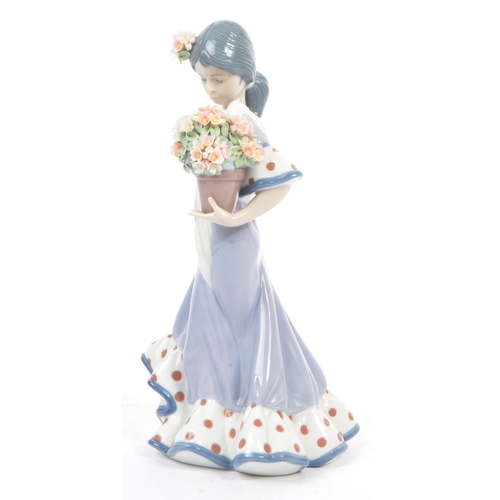 98 - Lladro - Flora Maria - A late 20th century circa 1980s porcelain china figurine. A Hispanic female h... 