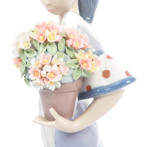 98 - Lladro - Flora Maria - A late 20th century circa 1980s porcelain china figurine. A Hispanic female h... 