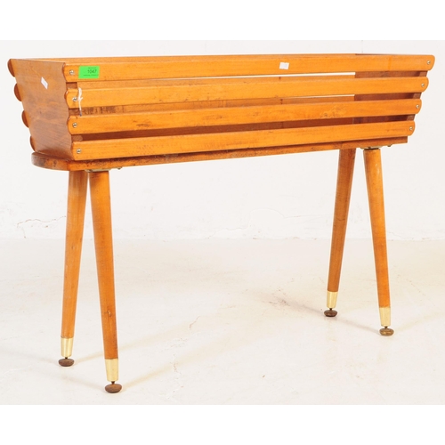 1047 - A vintage mid 20th century circa 1950s teak wood planter trough on feet. The tough having a squared ... 