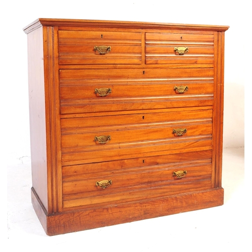 1050 - An early 20th century Edwardian walnut and satinwood chest of drawers. Rectangular form with flared ... 