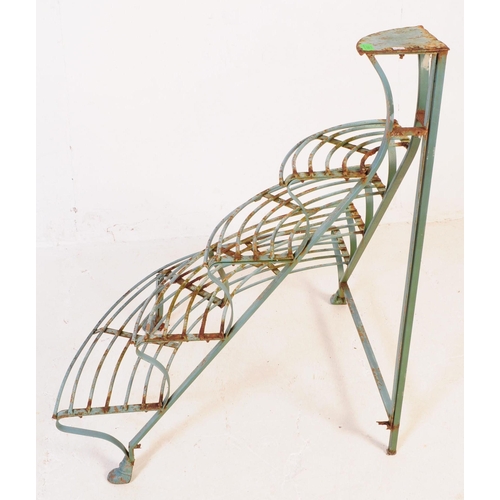 558 - A 20th century French manner painted iron corner plant stand etagere. The stand having four curved s... 