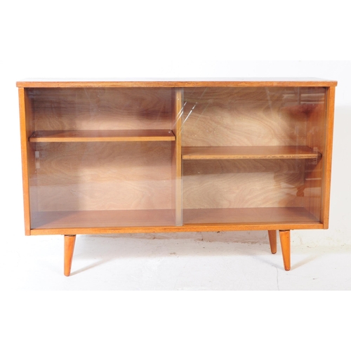 560 - British Modern Design - Mid century teak wood sliding glass door library bookcase. Raised on tapered... 