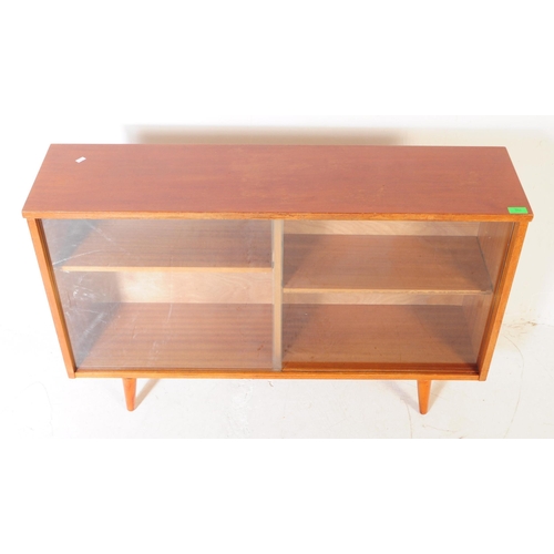 560 - British Modern Design - Mid century teak wood sliding glass door library bookcase. Raised on tapered... 