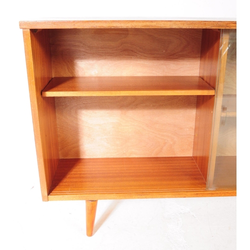 560 - British Modern Design - Mid century teak wood sliding glass door library bookcase. Raised on tapered... 