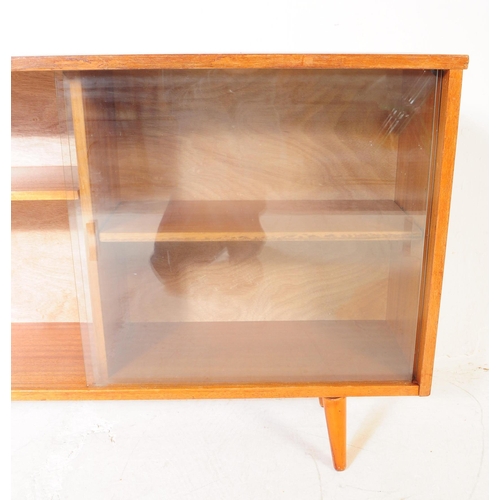 560 - British Modern Design - Mid century teak wood sliding glass door library bookcase. Raised on tapered... 