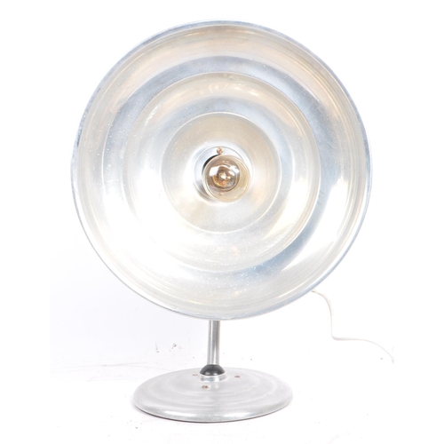 564 - A mid 20th century Estawa chromed metal circular wall lamp. The lamp having an oversized circular me... 