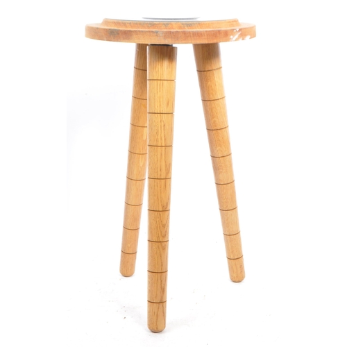 566 - A contemporary wood and resin stool / side table. The table raised on tapered legs with a turned woo... 