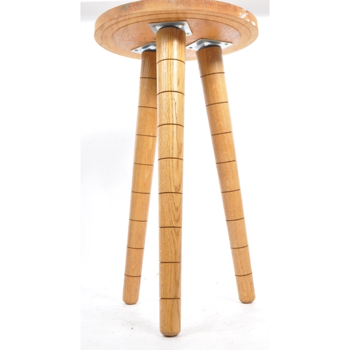 566 - A contemporary wood and resin stool / side table. The table raised on tapered legs with a turned woo... 