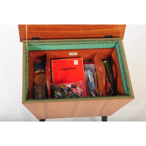 571 - A retro mid 20th century teak veneered sex table / box. Rectangular form hinged lid with contents on... 