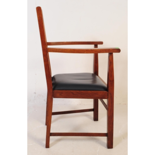 575 - An early 20th century oak Arts and Crafts carver dining chair. The chair having a drop in leather ov... 