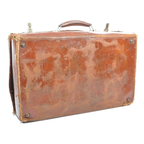 576 - A 20th century leather bound military suitcase trunk. The case of rectangular form, with brass latch... 