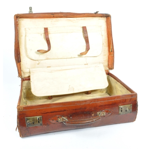 576 - A 20th century leather bound military suitcase trunk. The case of rectangular form, with brass latch... 