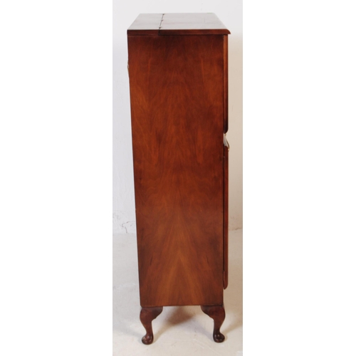 579 - A post war Art Deco walnut veneer drinks / cocktail cabinet. Rectangular form with pull down top cab... 