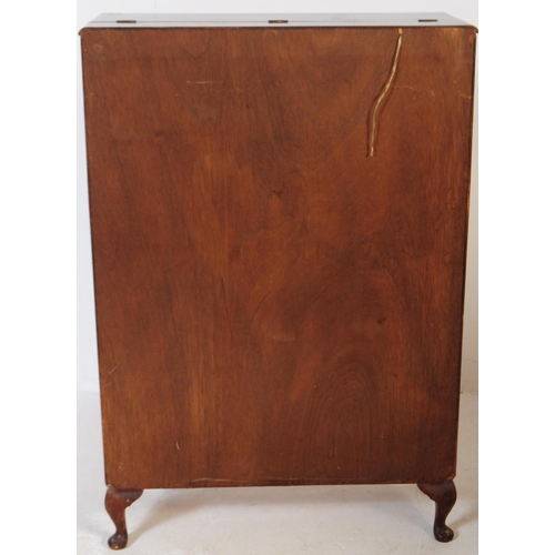 579 - A post war Art Deco walnut veneer drinks / cocktail cabinet. Rectangular form with pull down top cab... 