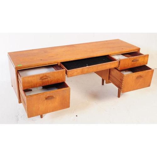 583 - Beithcraft Furniture - A mid 20th century teak writing office / school desk table. Rectangular form ... 