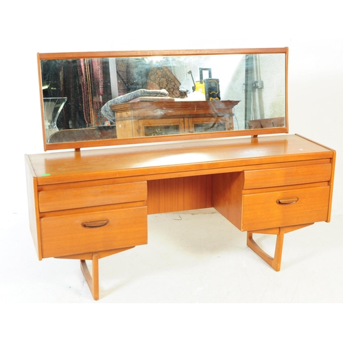 584 - British Modern Design - A retro mid 20th century teak dressing table. Rectangular form with knee hol... 