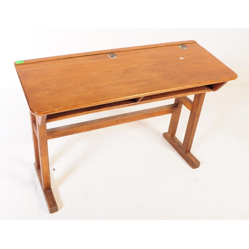 588 - A mid 20th century teak wood school writing draughtsmans desk. The desk raised on squared supports w... 