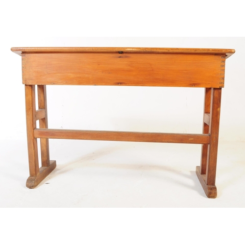 588 - A mid 20th century teak wood school writing draughtsmans desk. The desk raised on squared supports w... 