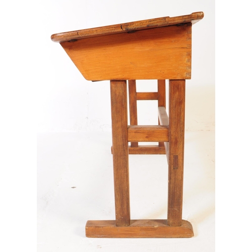 588 - A mid 20th century teak wood school writing draughtsmans desk. The desk raised on squared supports w... 